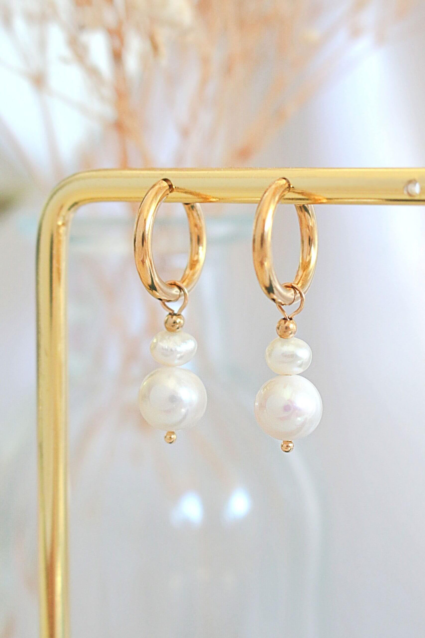 Minimalist pearl earrings featuring freshwater pearls and 24-karat yellow gold-plated stainless steel.